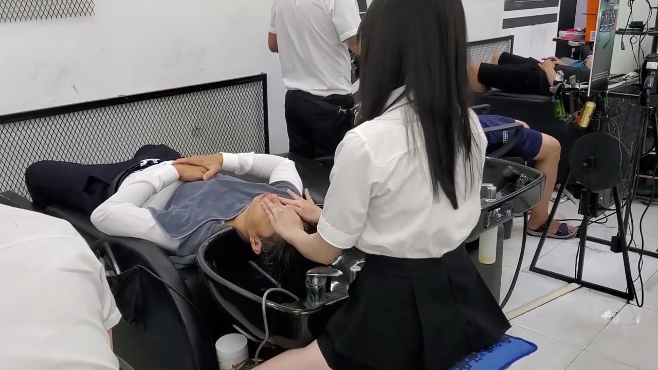 Relaxing shampoo and massage with a beautiful girl at a Vietnamese barber shop