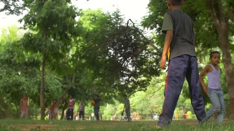 Indian Children Playing Football in a Park