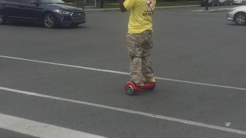 Black drunk man ride and dance on for way street