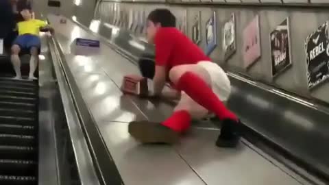 Young Boy plays foolish on an Escalator: WATCH TILL END