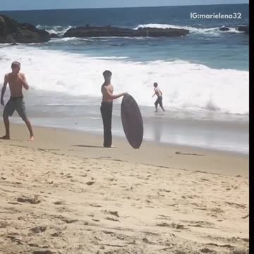 Guy in black jeans fails at jumping on surf board