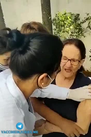 Nurses forcibly "vaccinating" a lady