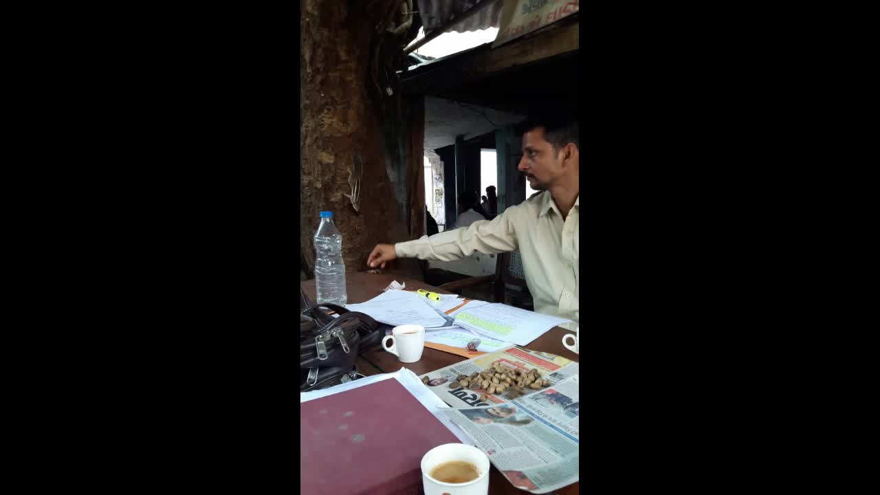 Man feeding nuts to hungry squirrel in India