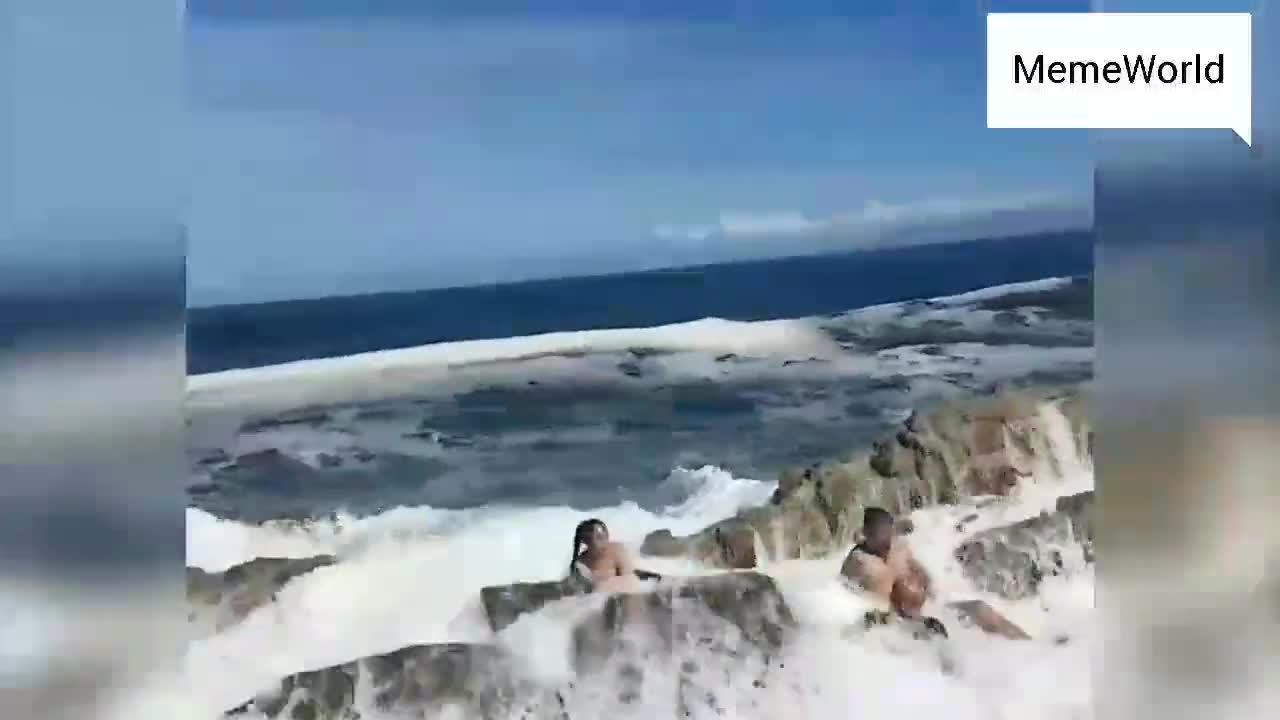 a huge wave slap this people while taking pictures