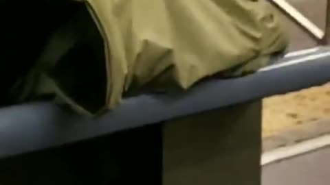 Pink zoom in man on subway sleeps under jacket