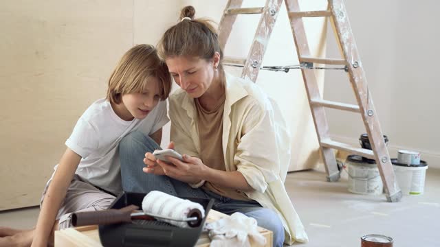 Adult and Child Looking at Phone
