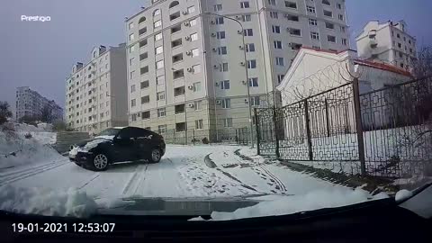 WOW!! Quick Thinking Driver Reverses Away from Sliding Car