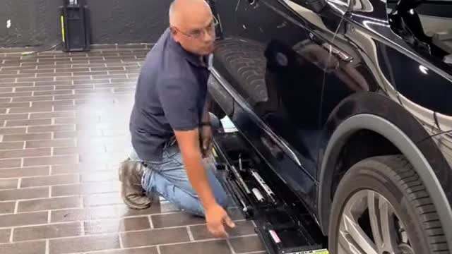 The repairman set up the car lifting equipment