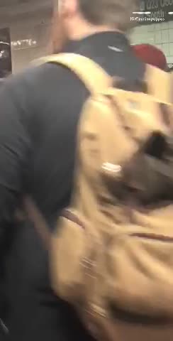 Man in black jacket squirrel on shoulder