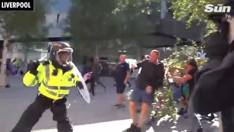 Thugs target migrant hotels, clash with cops & set cars on fire as riots sweep across UK