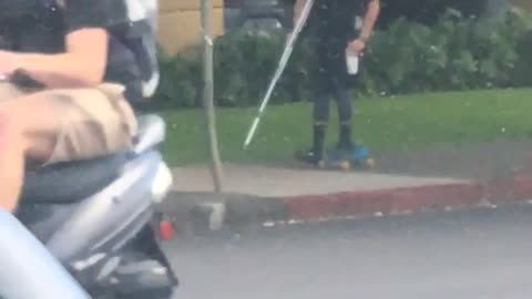 Guy in black shirt skating with broken leg