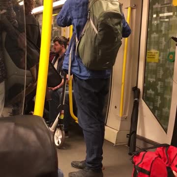 Man in blue plays flute on subway