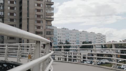 A Man Running on a Pedestrian Overpass