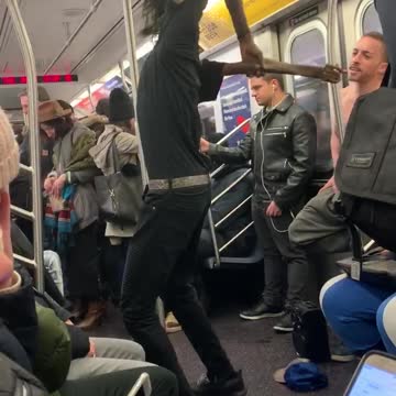 Contortionist guy bends his arms backwards and dances on subway train