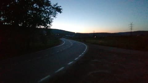 Motorcycle roller-car rolls, evening sunset