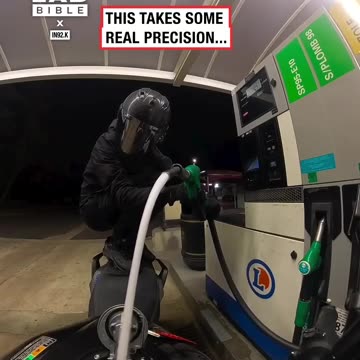 Person is putting gas into their bike from long distances 😲