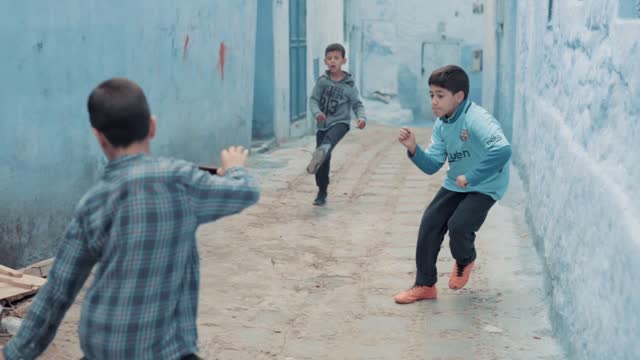 kids playing football in moroccon streets