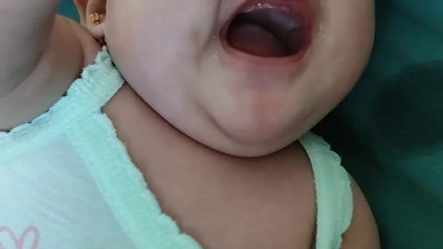 baby doesn't know if she will cry or laugh