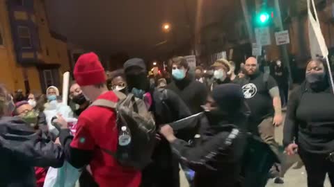 Socialists and blm argue over a banner.