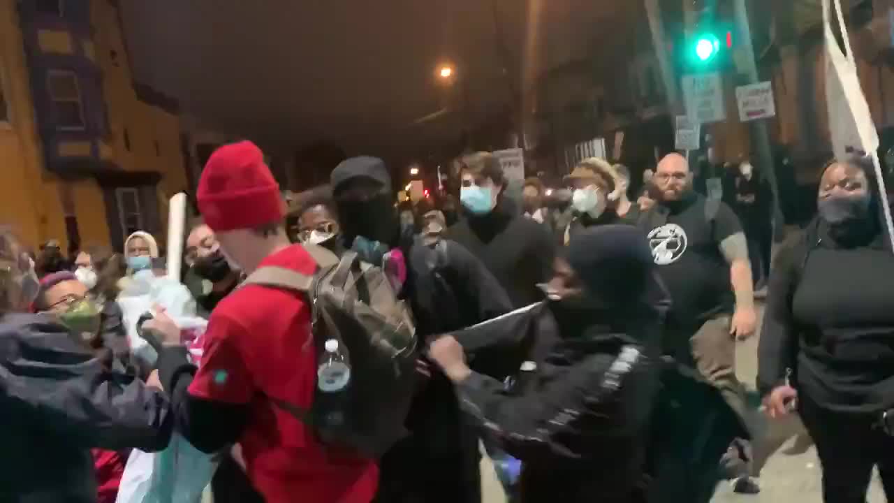 Socialists and blm argue over a banner.