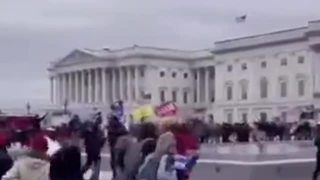 Capitol cop waving people in past the gates