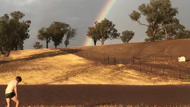 Happy Farmer Splashing in Rain Puddles