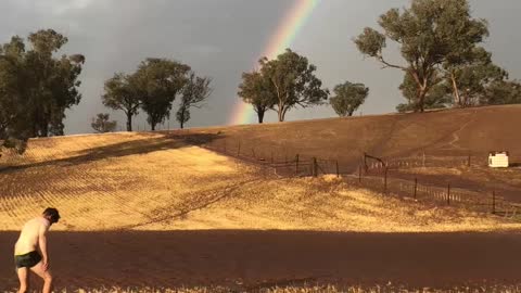 Happy Farmer Splashing in Rain Puddles