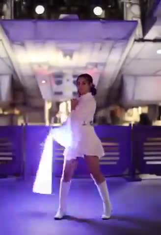 A girl playing with a lightsaber