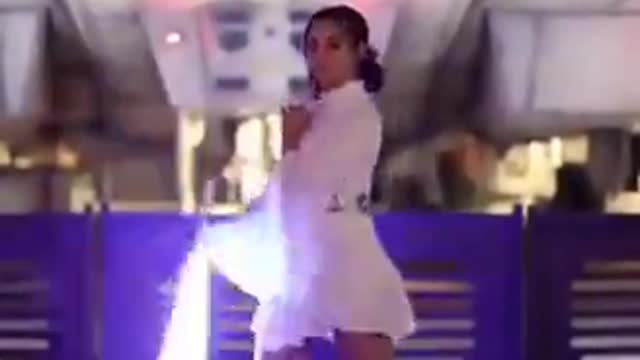 A girl playing with a lightsaber