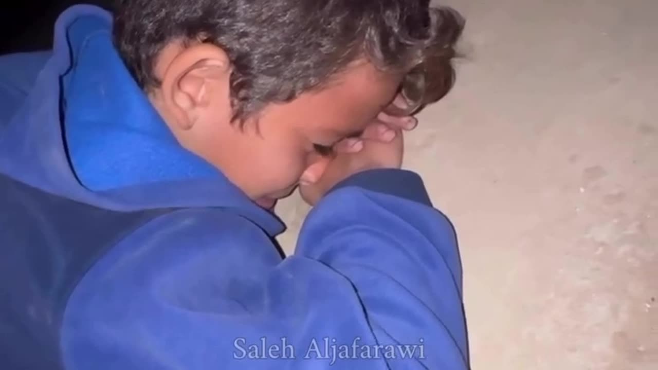 Saleh Aljafarawi comforts an orphan