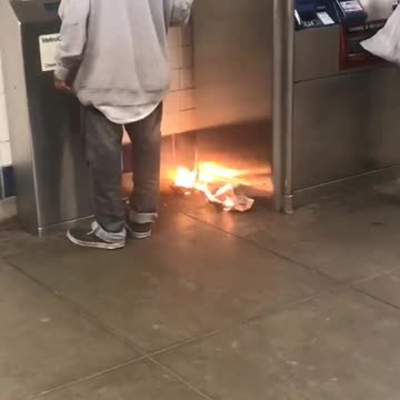 Small fire subway station next to trashcan and atm