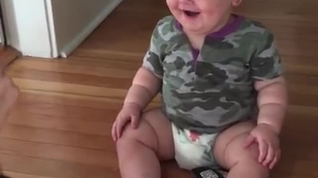 Baby laughing hysterically at mom's sunglass trick