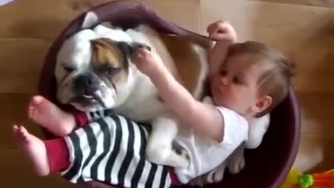 Baby sleeping in bed with bulldog