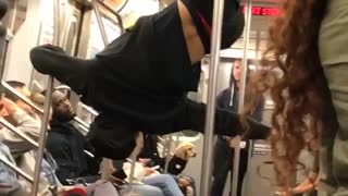 Man in black outfit dancing on train