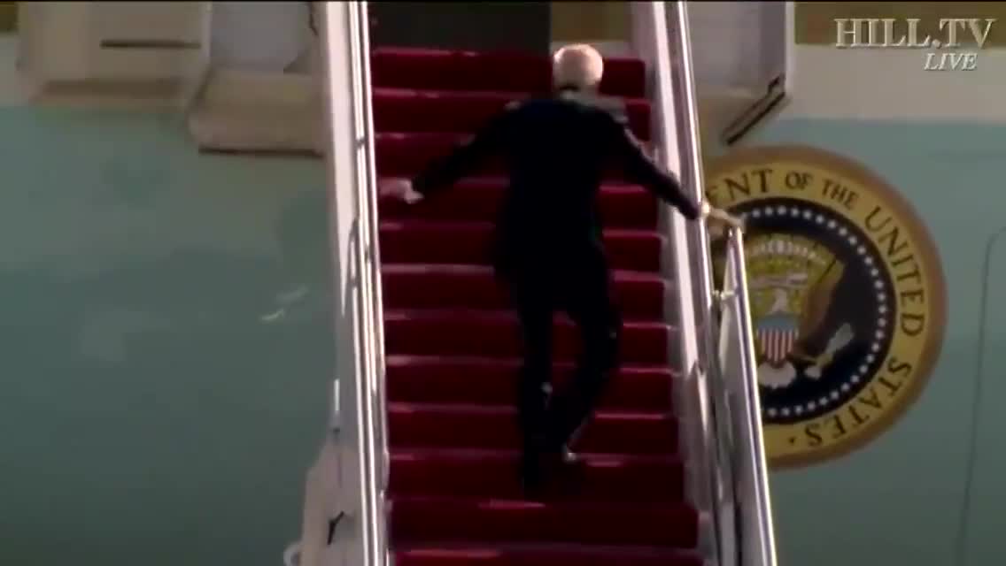 Joe Biden falls several times as he walked up the stairs of Airforce One plane