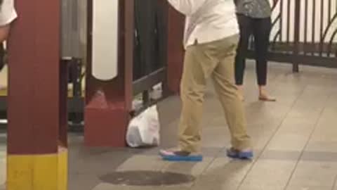 Guy long white shirt punching sign on wall