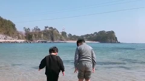 Children dipping their feet in the sea