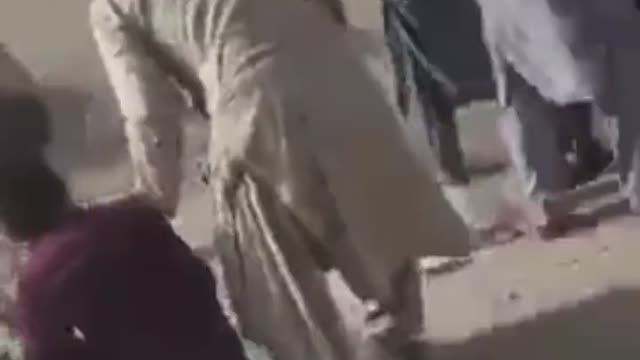 Taliban members firing shots at crowds of people