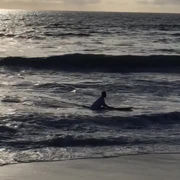 Guy rides white board with no fins