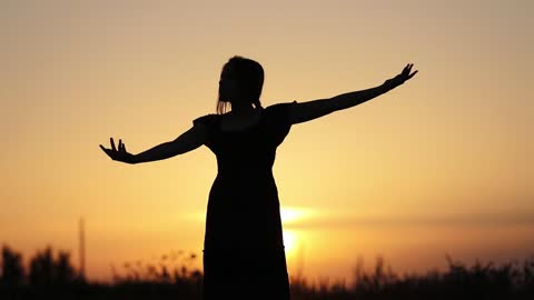 Girl dancing with sunset