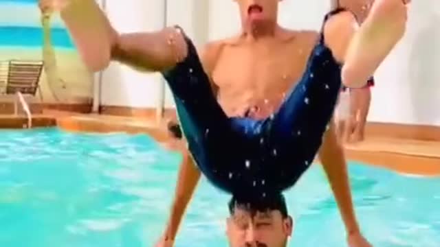 GUY JUMPS ON HEAD IN POOL