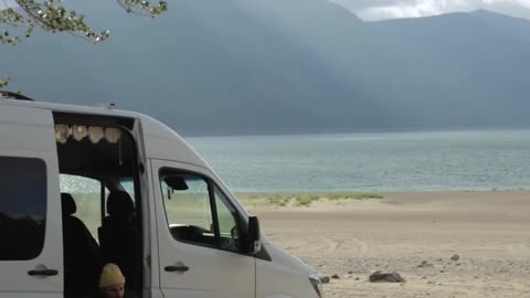 a-man-and-woman-playing-with-their-pets-at-the-beach-