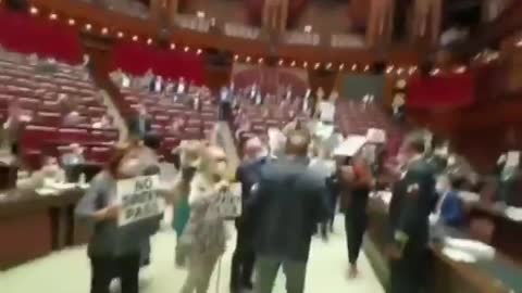 Italian parliament MPs holding up signs opposing the vaccine passport.