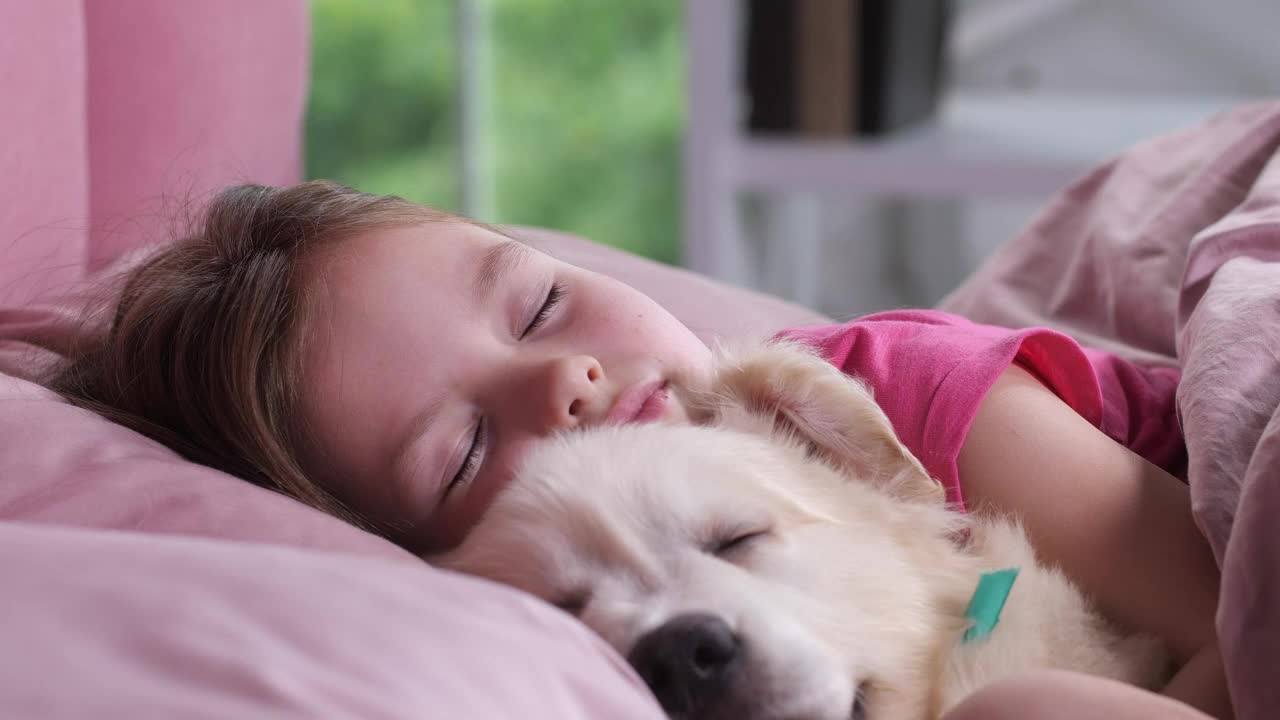 Young girl taking a nap with her puppy