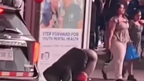 African immigrant poops at bus stop in Toronto's famous square.