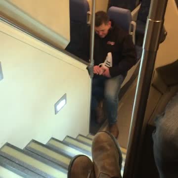 Man holds a foot on subway train