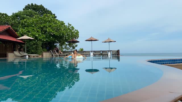 Couple Swims in Infinity Pool