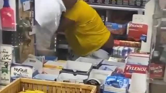 Woman goes behind the counter to fight the cashier. Wins a prize