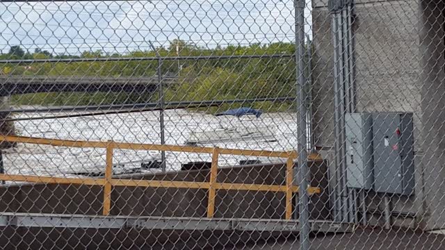 Pontoon Boat Floats Down Dam