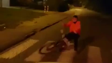 Bike tied to car and guy on bike falls